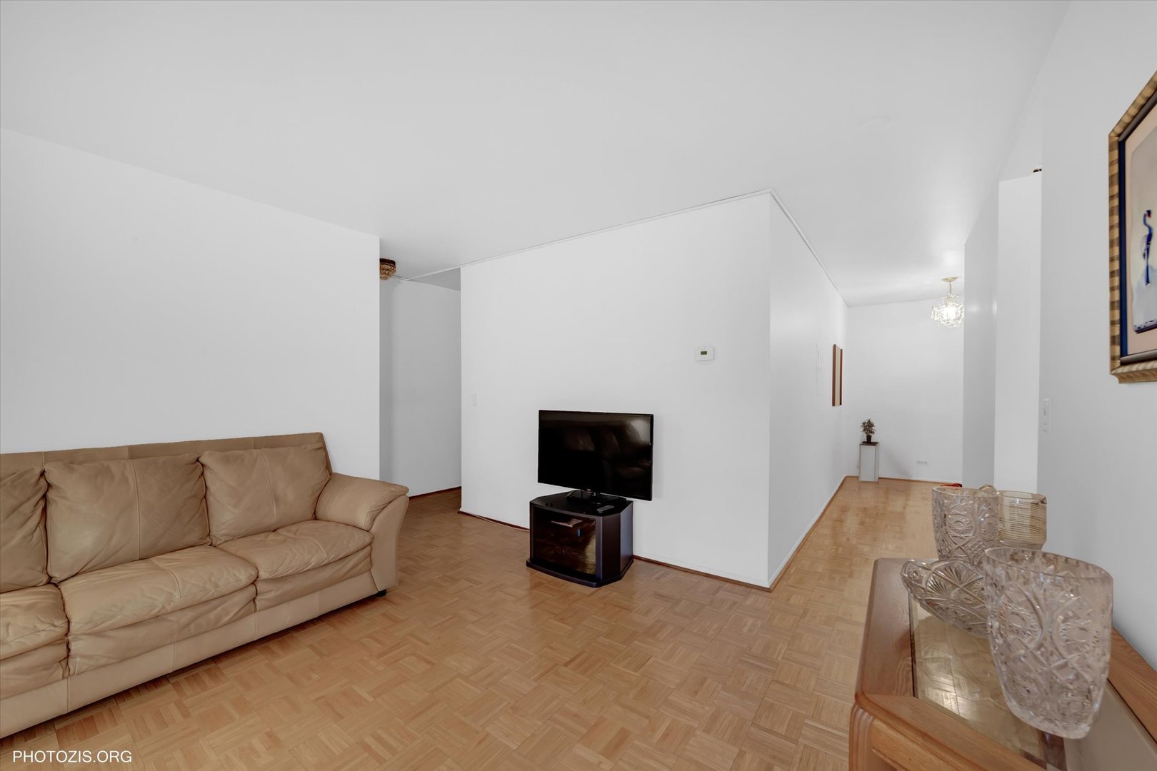 4838 West Howard Street, Unit 301 Skokie, IL 60077 - Photo 14 of 32 a living room with furniture and a flat screen tv