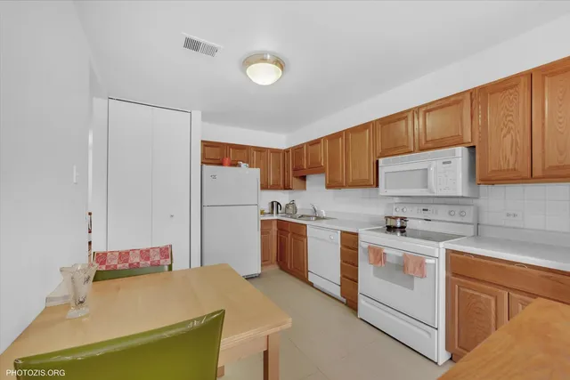a kitchen with a sink stove and white cabinets