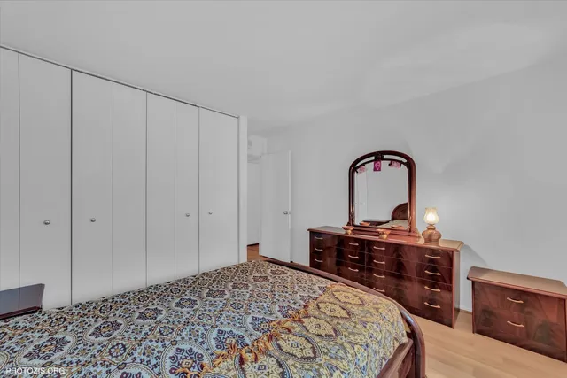 a bedroom with a bed and a desk