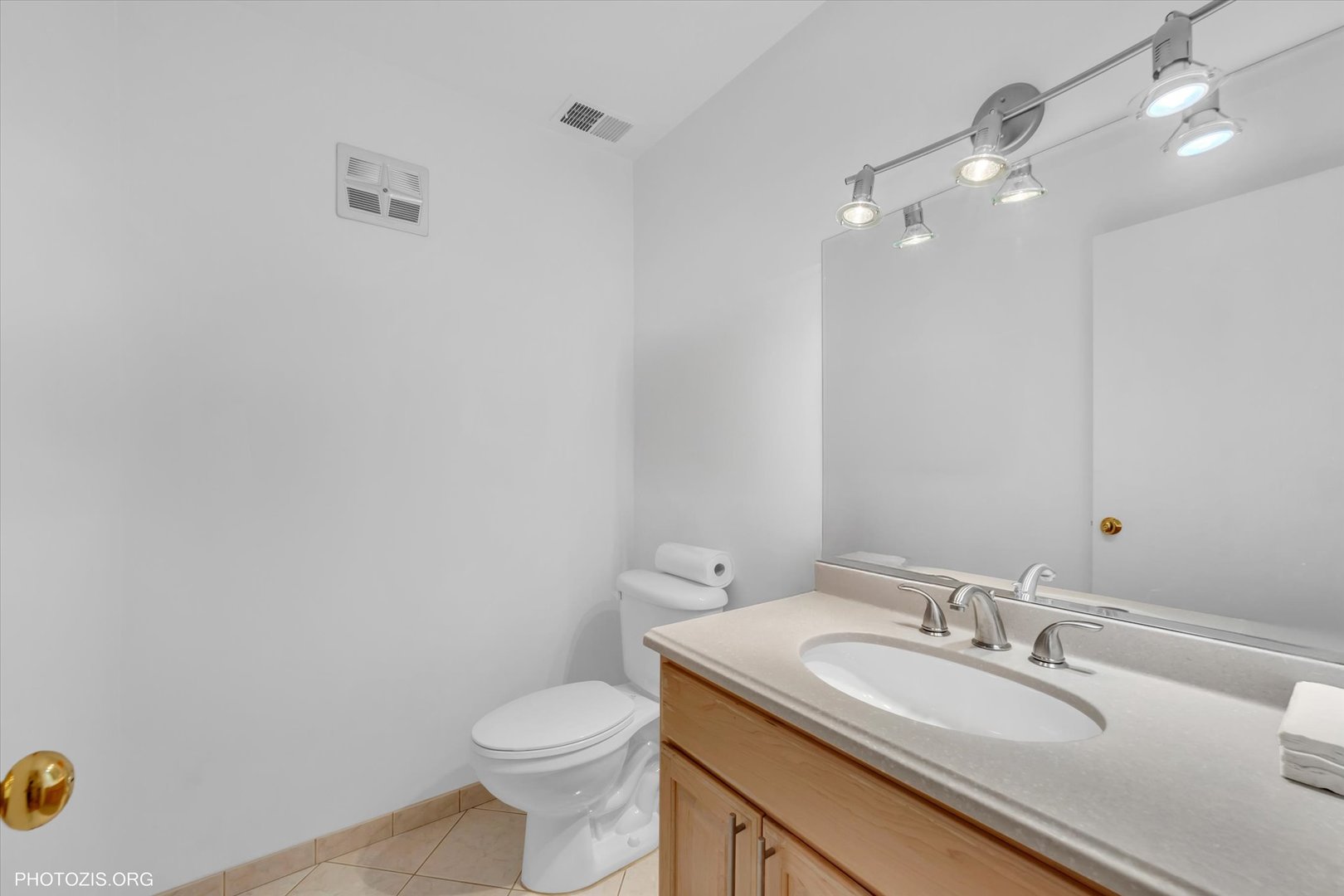 4838 West Howard Street, Unit 301 Skokie, IL 60077 - Photo 24 of 32 a bathroom with a granite countertop sink a toilet and a mirror