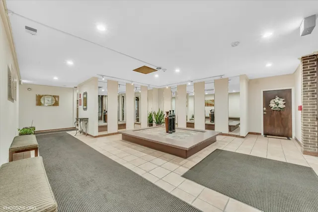 a large bedroom with a large bed and glass doors