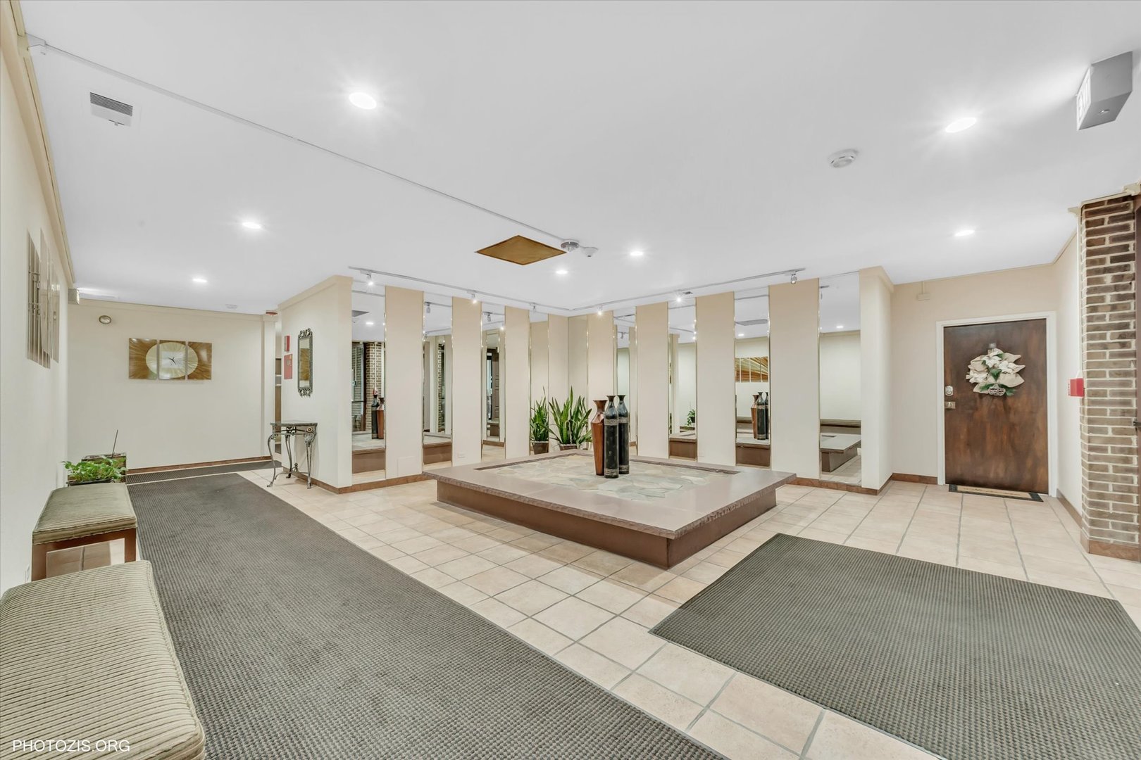 4838 West Howard Street, Unit 301 Skokie, IL 60077 - Photo 5 of 32 a large bedroom with a large bed and glass doors