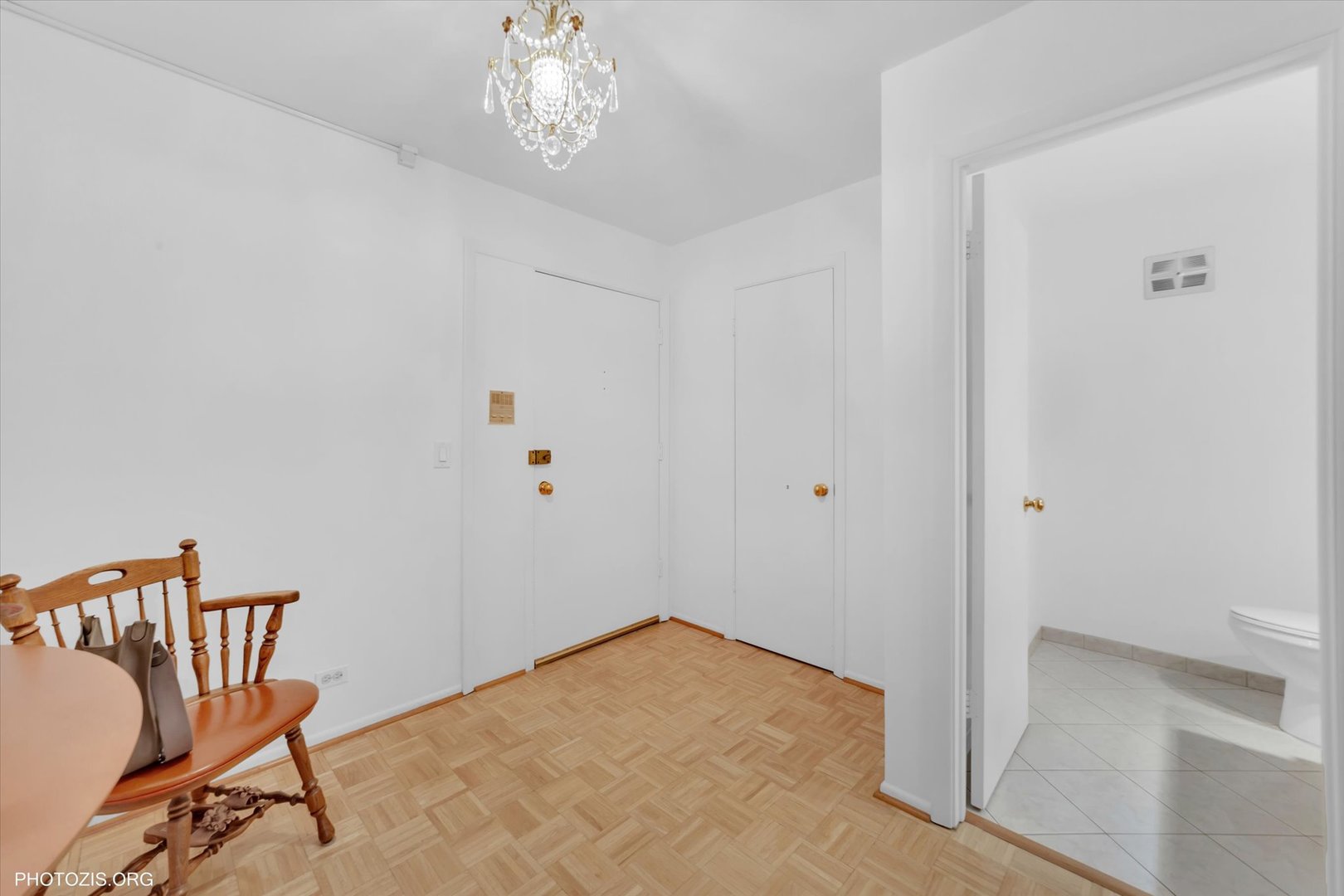 4838 West Howard Street, Unit 301 Skokie, IL 60077 - Photo 9 of 32 a view of a hallway with wooden floor and a chandelier