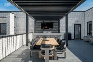 a view of a patio with table and chairs with wooden floor and fence