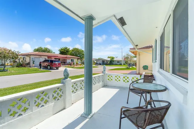 a view of a chairs and table in patio with a yard