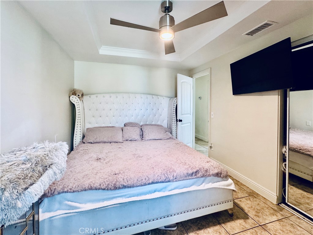 8735 Calaveras Avenue Rancho Cucamonga, CA 91730 - Photo 17 of 52 a bedroom with a bed dresser and a walk in closet