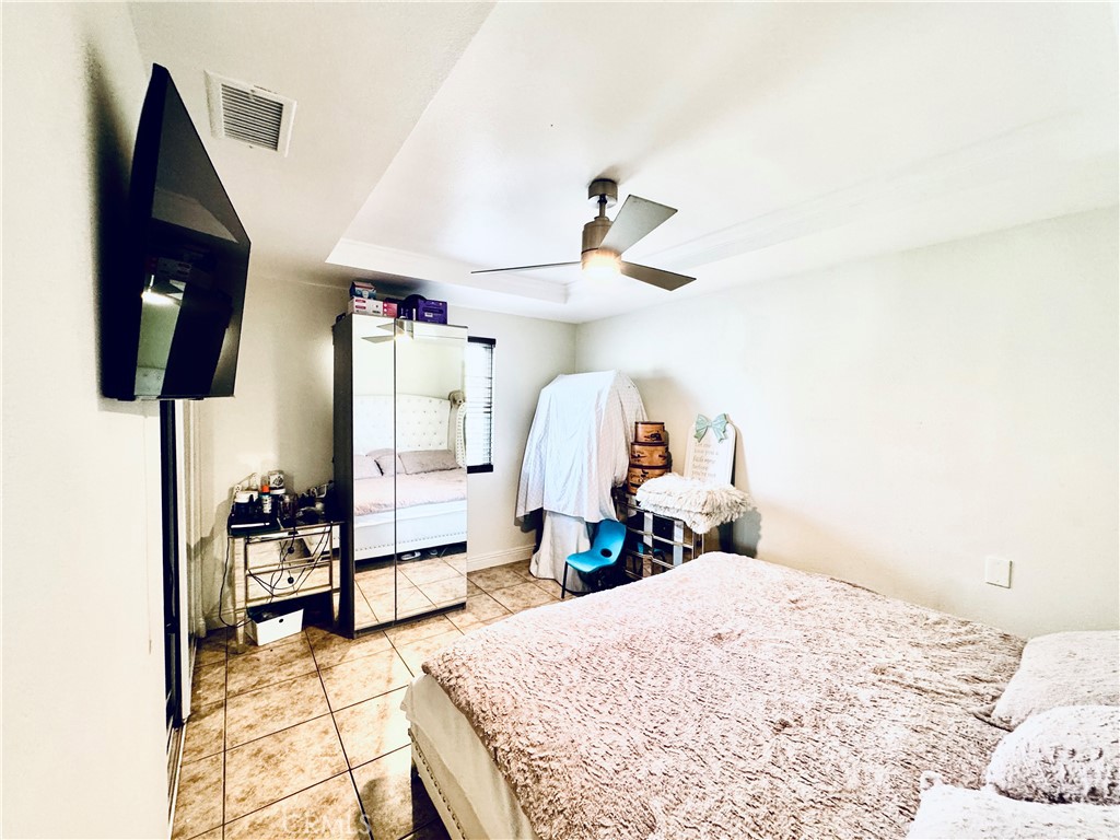 8735 Calaveras Avenue Rancho Cucamonga, CA 91730 - Photo 18 of 52 a bedroom with a bed and a chandelier