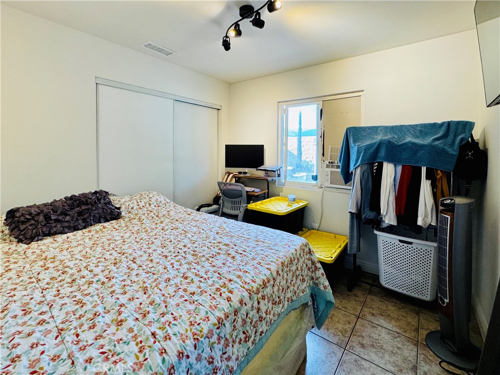 8735 Calaveras Avenue Rancho Cucamonga, CA 91730 - Photo 20 of 52 a bedroom with a bed and wooden floor