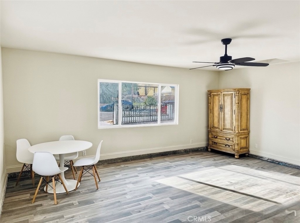 8735 Calaveras Avenue Rancho Cucamonga, CA 91730 - Photo 26 of 52 a view of a room with a wooden table and chairs