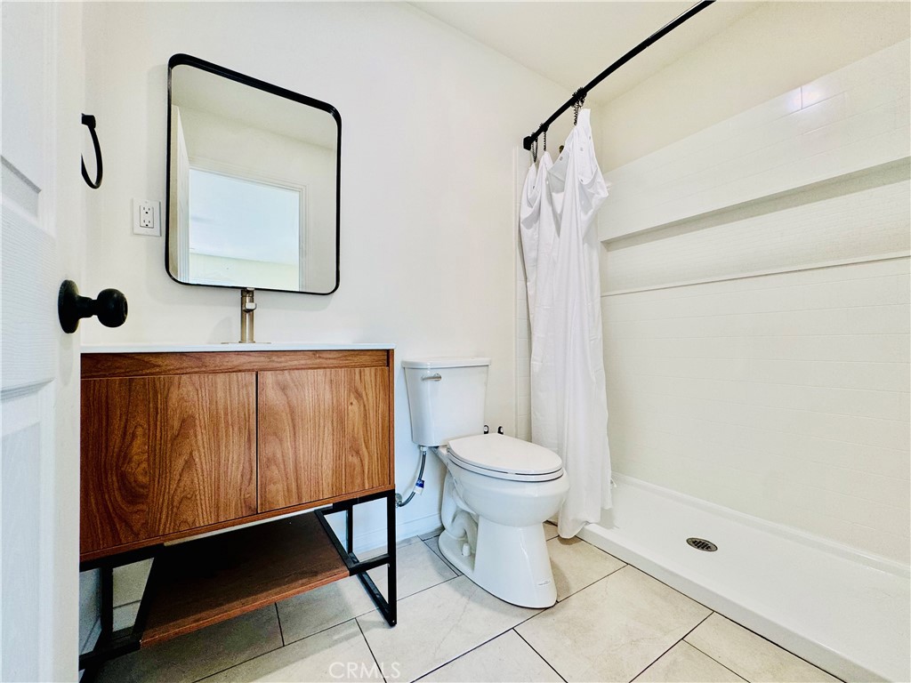 8735 Calaveras Avenue Rancho Cucamonga, CA 91730 - Photo 31 of 52 a bathroom with a toilet a sink and mirror