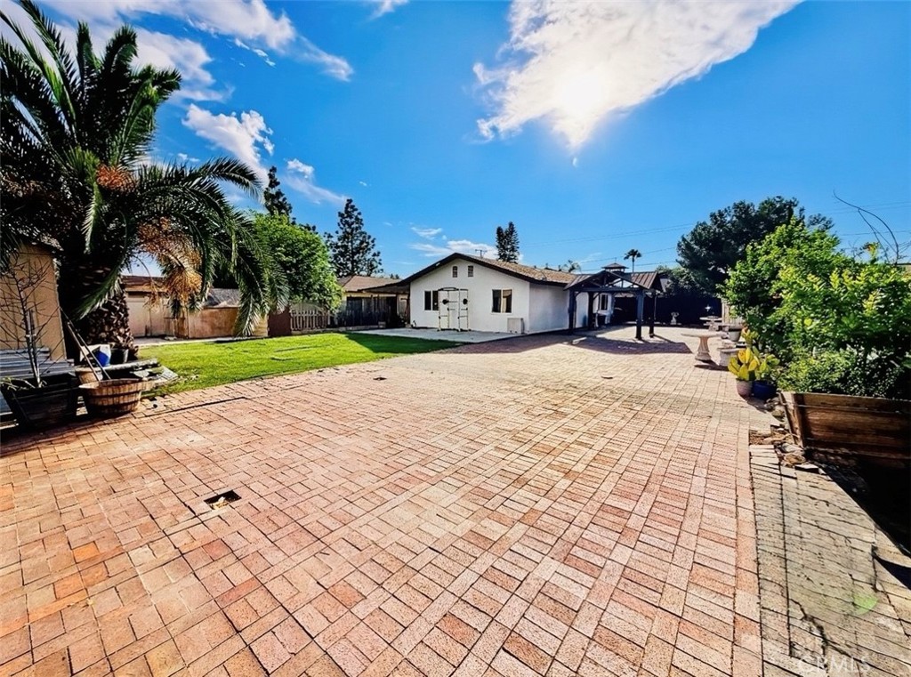 8735 Calaveras Avenue Rancho Cucamonga, CA 91730 - Photo 40 of 52 a view of swimming pool with outdoor seating and trees in the background