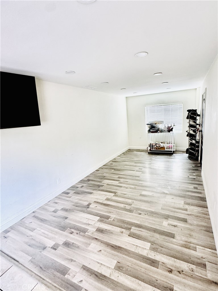 8735 Calaveras Avenue Rancho Cucamonga, CA 91730 - Photo 8 of 52 a view of empty room with wooden floor