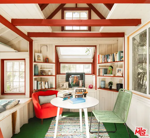 a living room with furniture a rug and a large window