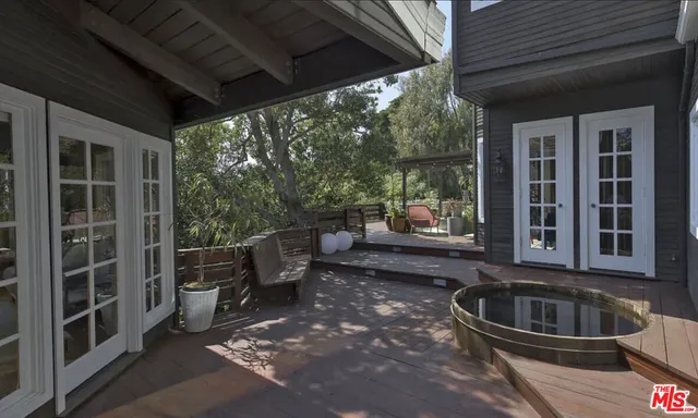 a view of a porch with furniture and floor to ceiling window