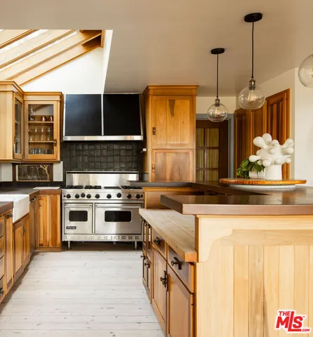 a kitchen with stainless steel appliances granite countertop a stove and a sink