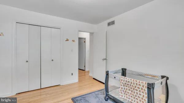 a view of a bedroom with wooden floor