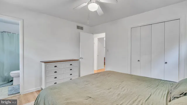 a bedroom with a bed and a dresser