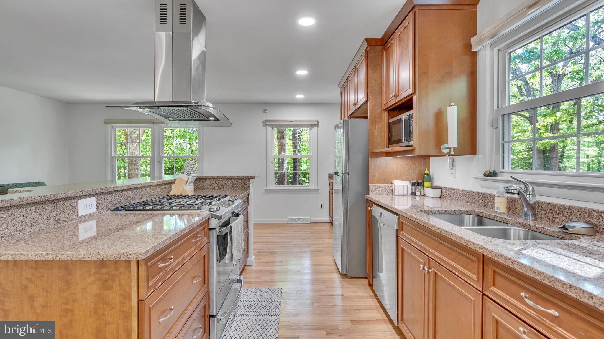 24680 Morgan Road Hollywood, MD 20636 - Photo 8 of 34 a kitchen with stainless steel appliances granite countertop a sink a stove and a refrigerator