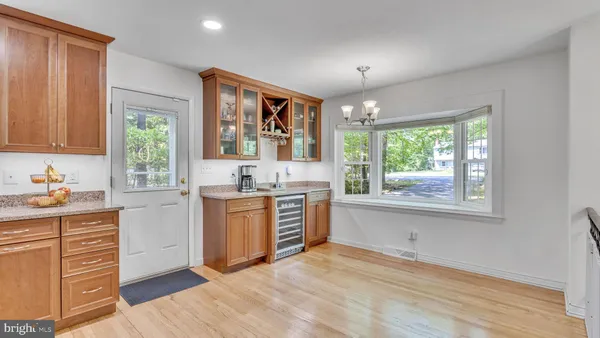 a kitchen with a window wooden floor and stainless steel appliances