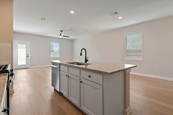 a kitchen with sink and cabinets