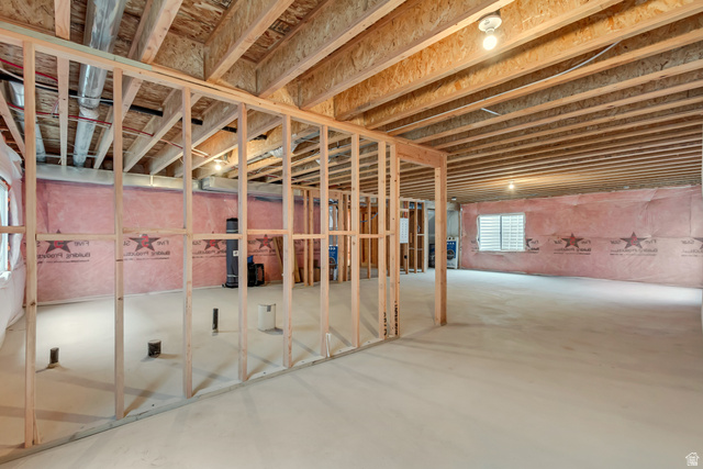 1389 1440 East, Unit 1 Payson, UT 84651 - Photo 17 of 17 Unfinished basement featuring extensive wood framing, exposed ceiling joists, concrete flooring, insulated exterior walls, and multiple windows