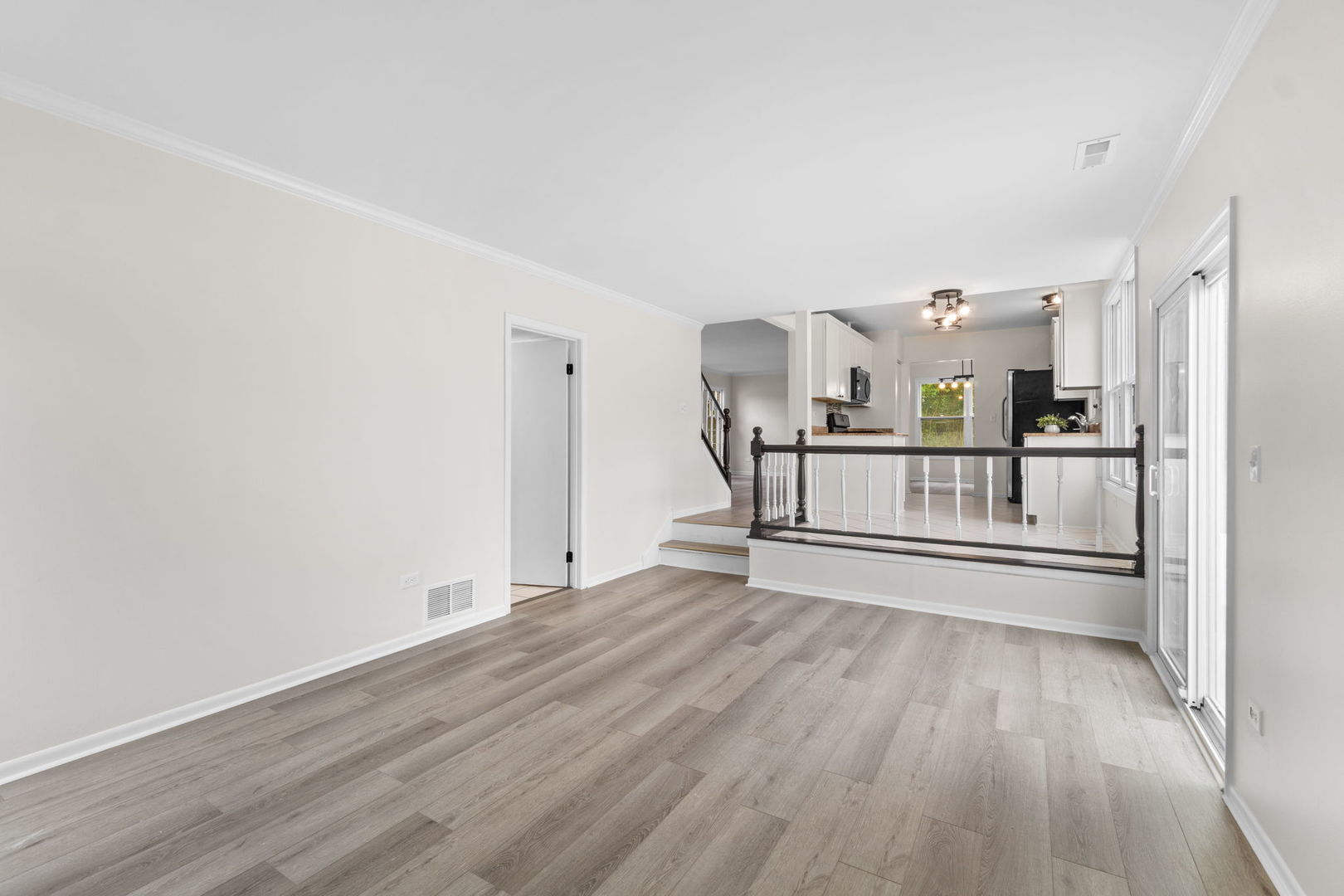 2254 Blacksmith Drive Wheaton, IL 60189 - Photo 14 of 32 a view of a living room hardwood floor and a kitchen