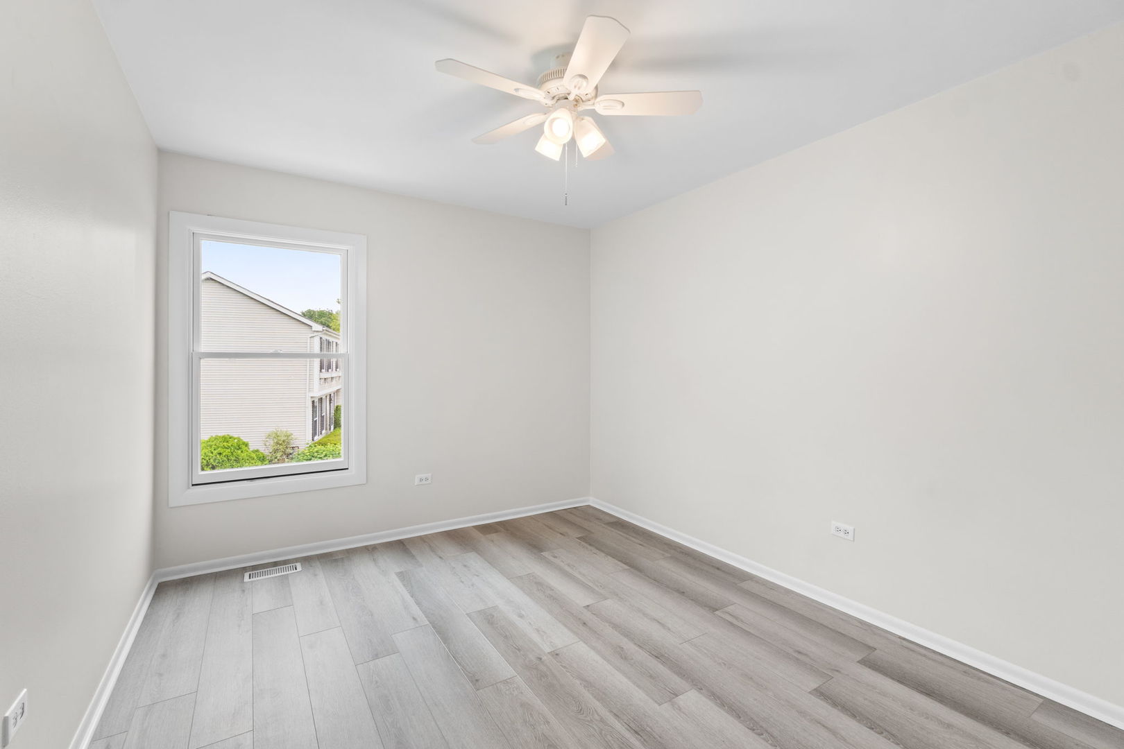 2254 Blacksmith Drive Wheaton, IL 60189 - Photo 17 of 32 an empty room with a window and a ceiling fan
