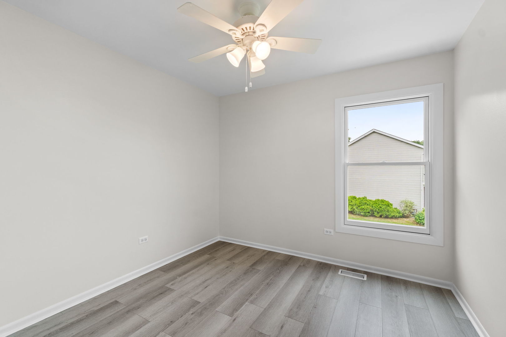2254 Blacksmith Drive Wheaton, IL 60189 - Photo 19 of 32 an empty room with a window and a fan