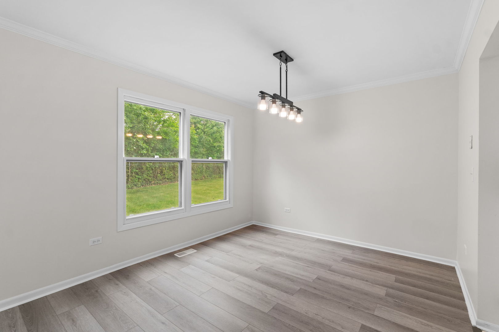 2254 Blacksmith Drive Wheaton, IL 60189 - Photo 6 of 32 a view of an empty room with wooden floor and a window