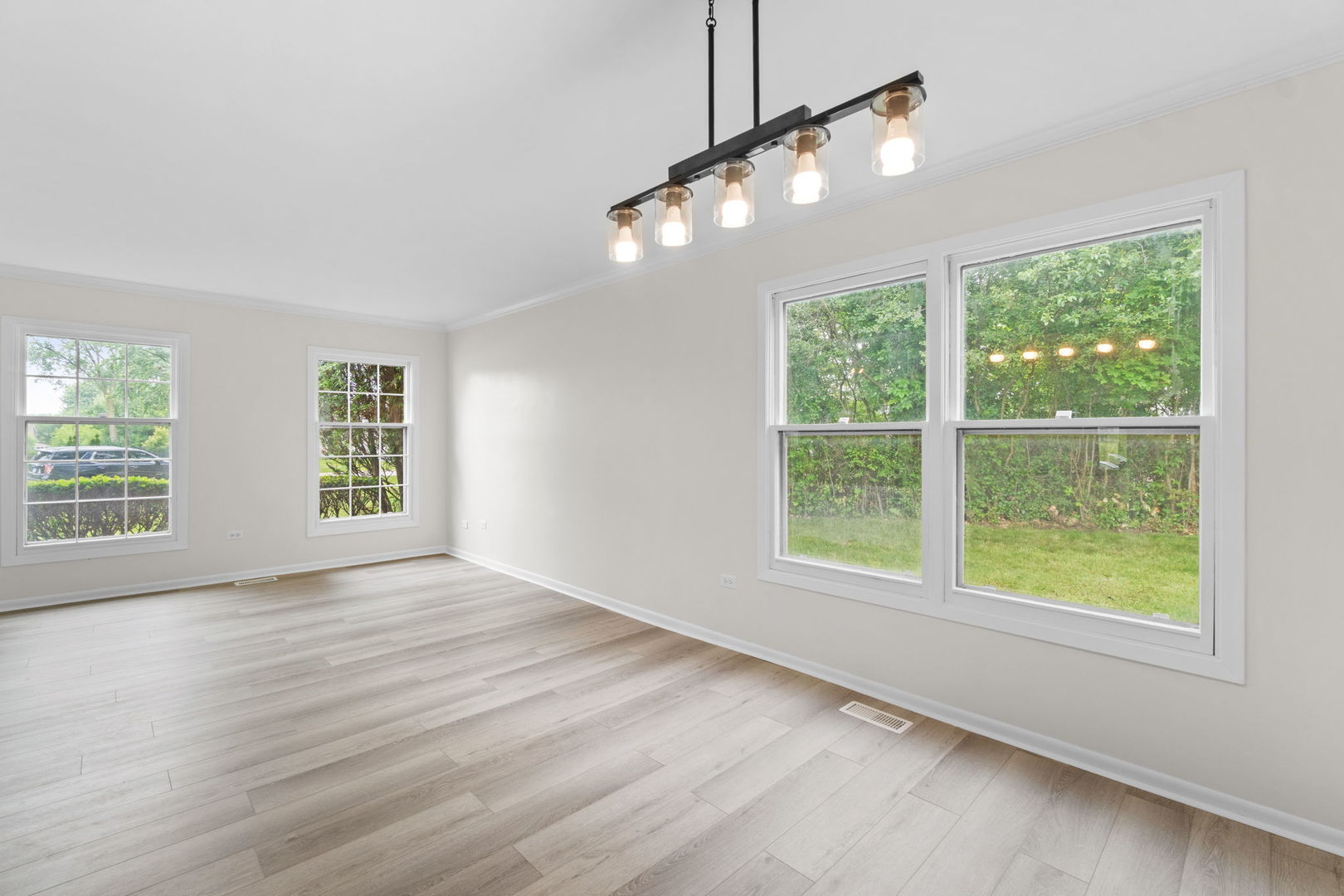 2254 Blacksmith Drive Wheaton, IL 60189 - Photo 7 of 32 a view of an empty room with wooden floor and a window
