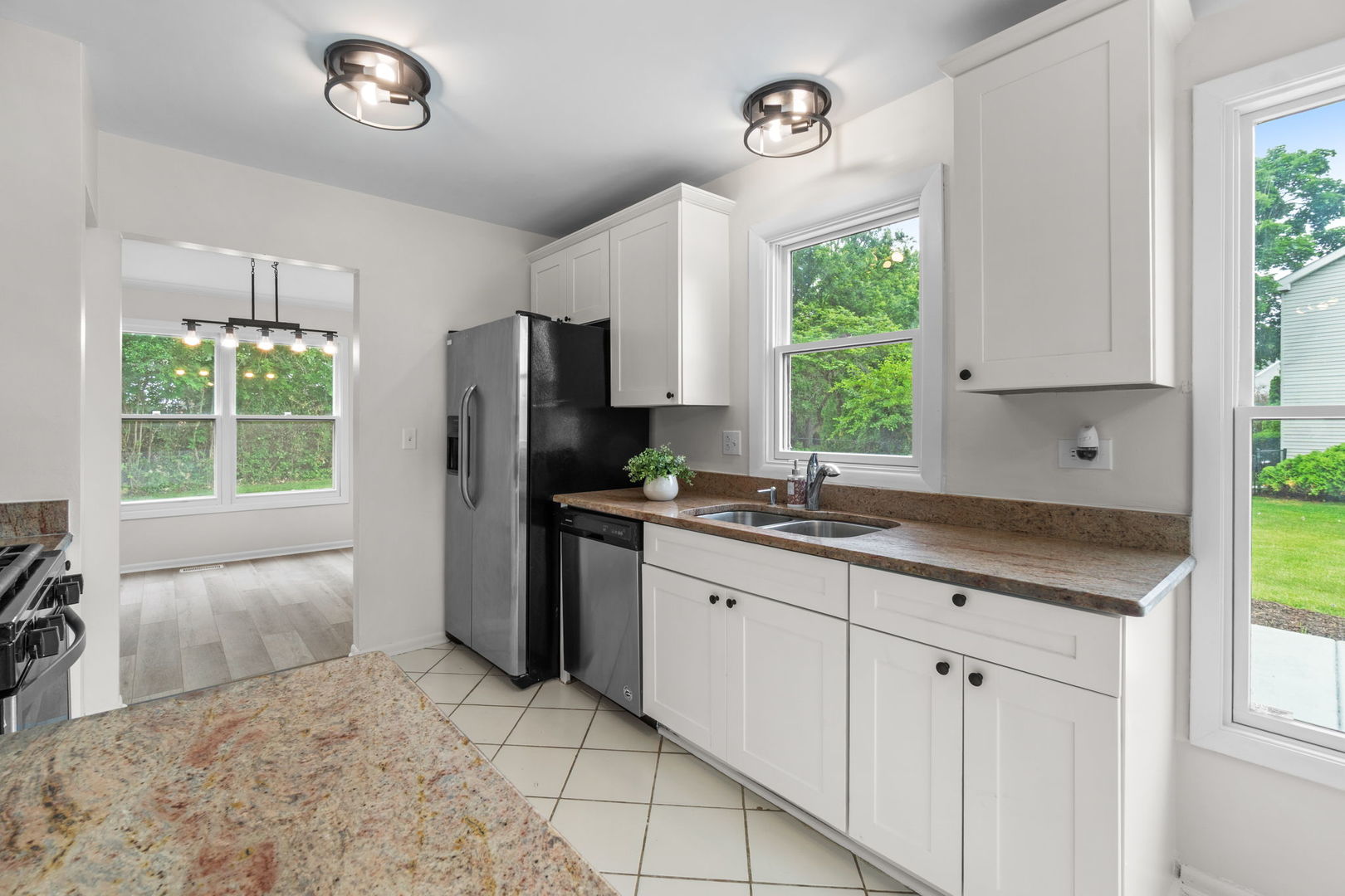 2254 Blacksmith Drive Wheaton, IL 60189 - Photo 8 of 32 a kitchen with a refrigerator a sink cabinets and a window