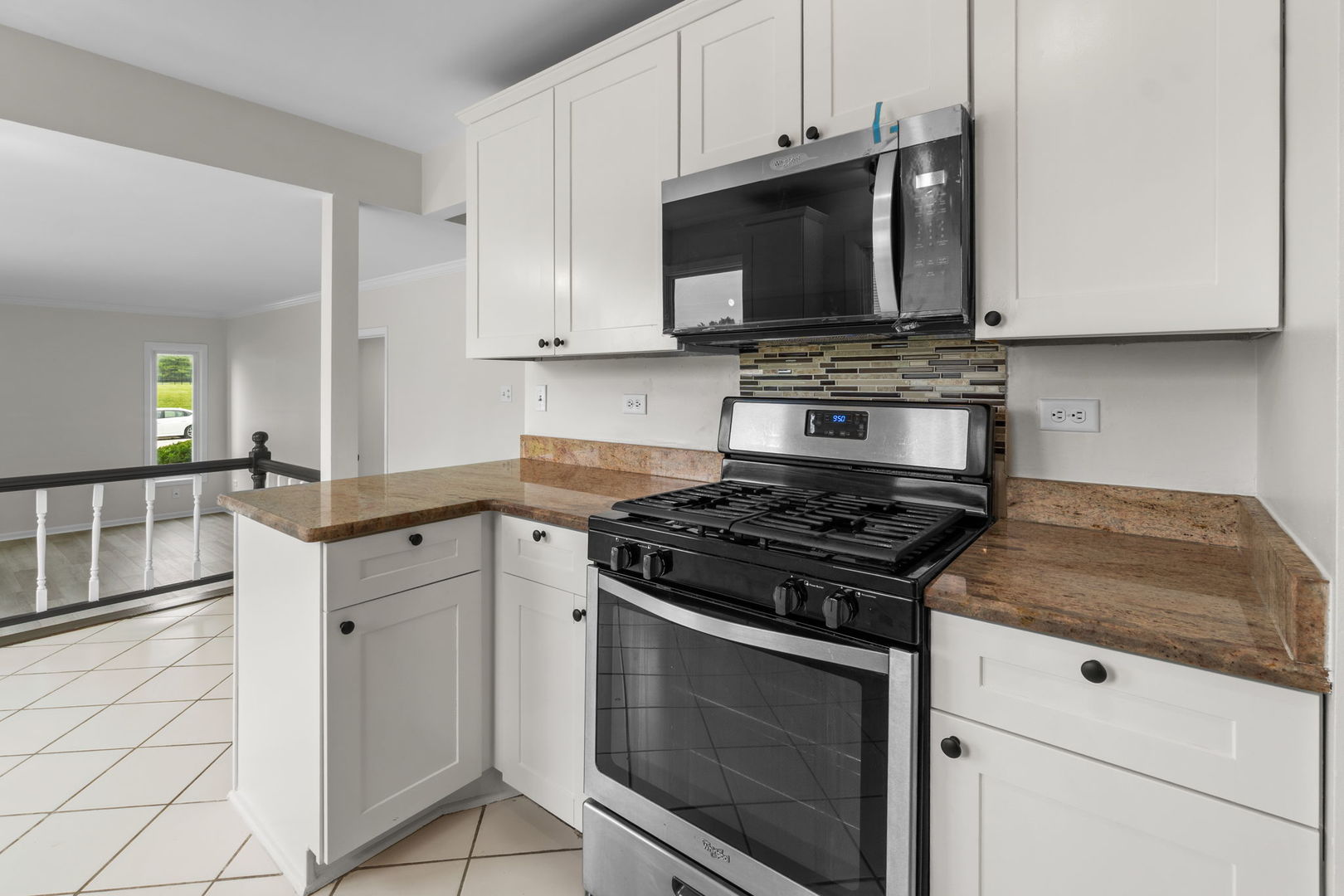 2254 Blacksmith Drive Wheaton, IL 60189 - Photo 9 of 32 a kitchen with granite countertop a stove and a microwave