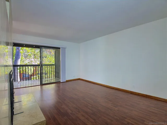 a dining room with furniture large windows and a chandelier