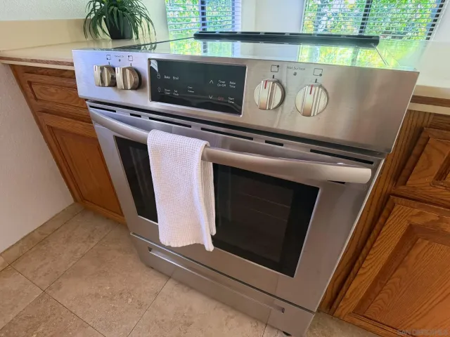 a view of a storage and utility room with washer and dryer