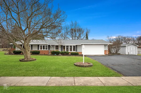 a front view of a house with a garden