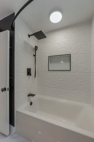 a bathroom with a bathtub and a shower