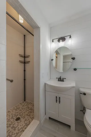 a bathroom with a sink a toilet and mirror