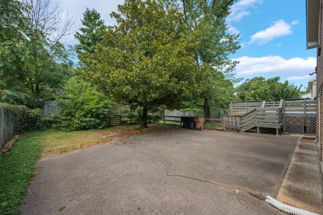 a view of backyard with outdoor seating and green space