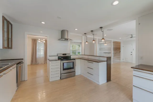 a large kitchen with cabinets and stainless steel appliances