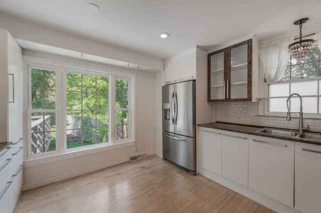 a kitchen with a refrigerator and window