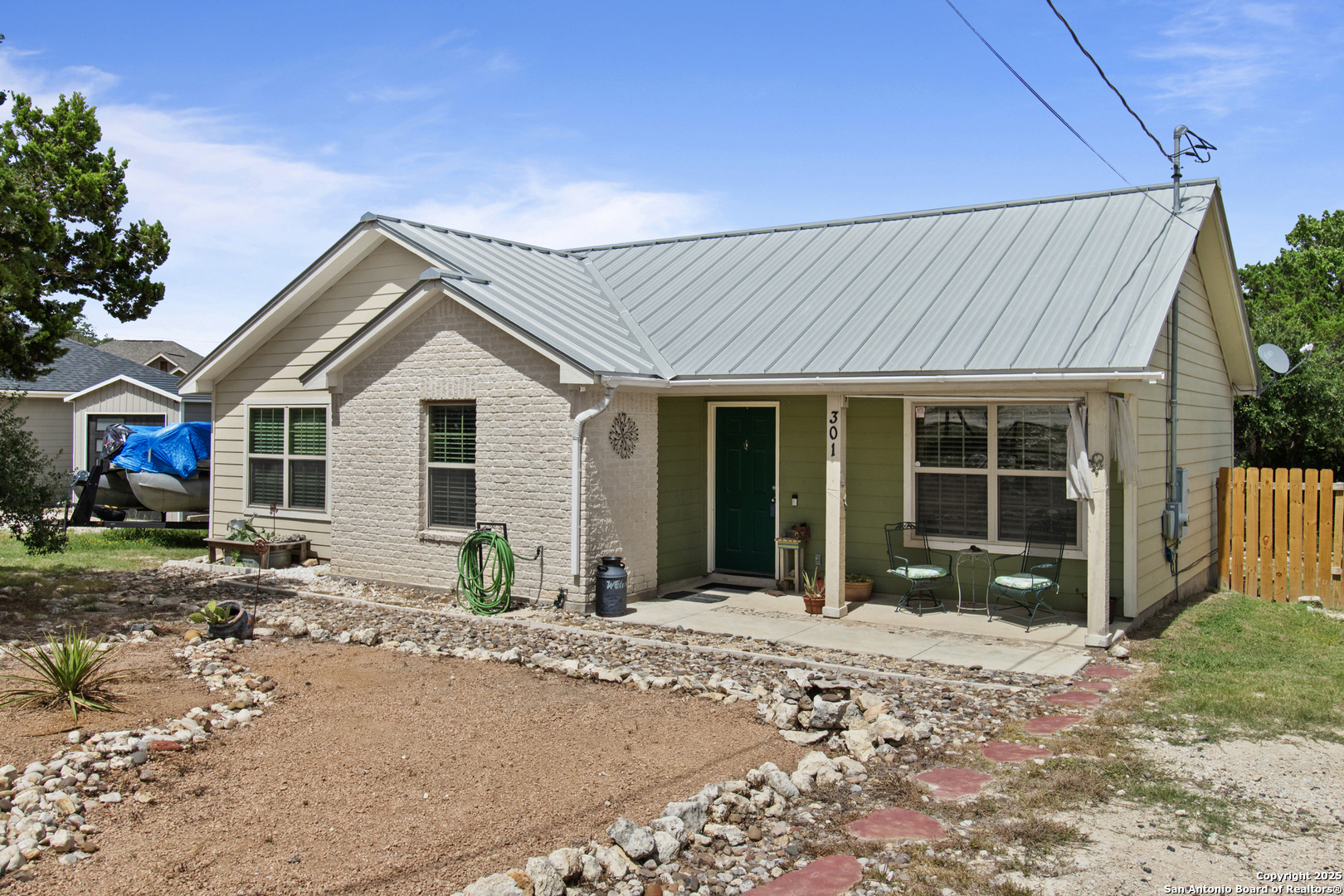 a front view of a house with a garden and patio