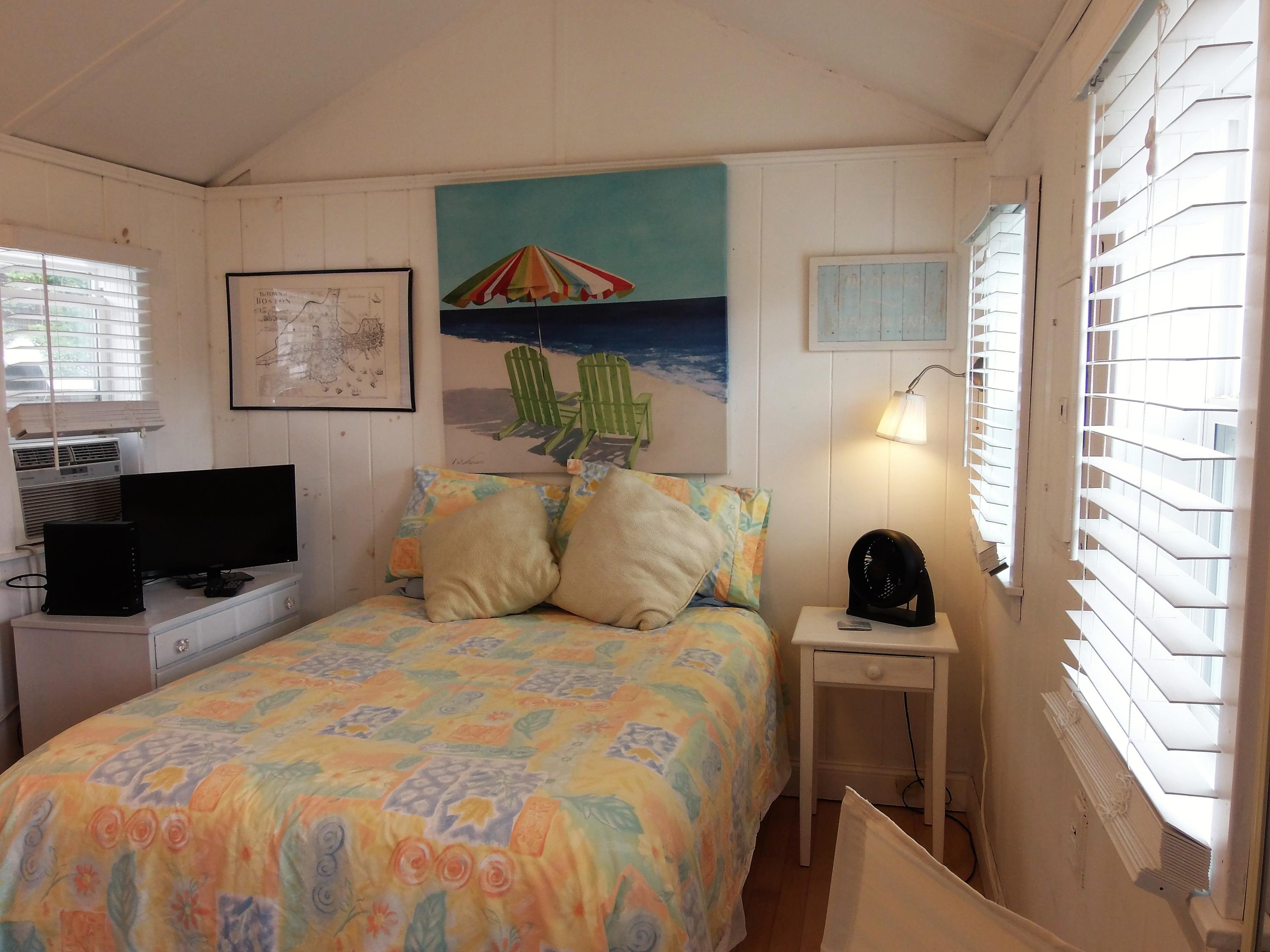 94 Old Wharf Road, Unit U1 Dennis Port, MA 02639 - Photo 3 of 10 a bedroom with a bed and a flat screen tv