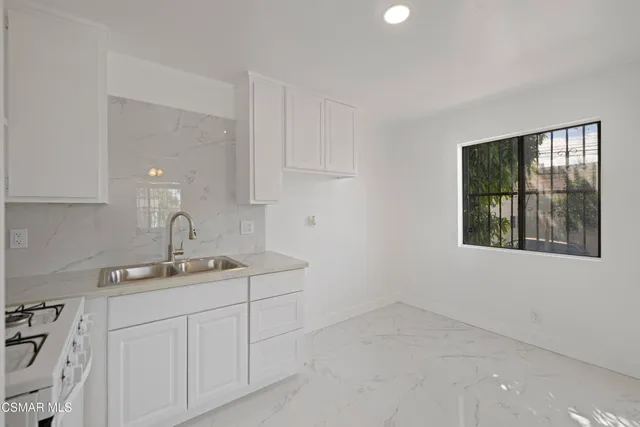a bathroom with a sink vanity and tub