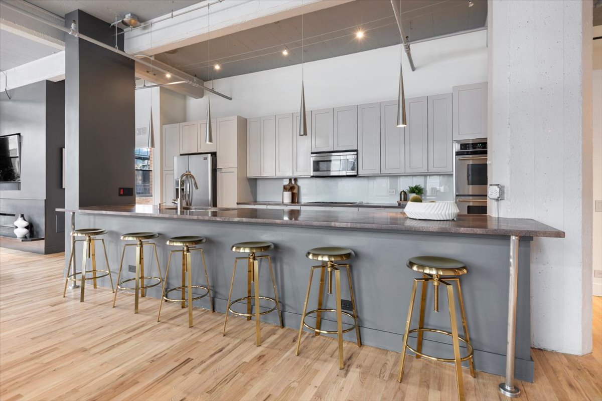 850 West Adams Street, Unit 4A Chicago, IL 60607 - Photo 21 of 52 a kitchen with stainless steel appliances granite countertop a stove a sink dishwasher a refrigerator and white cabinets with wooden floor