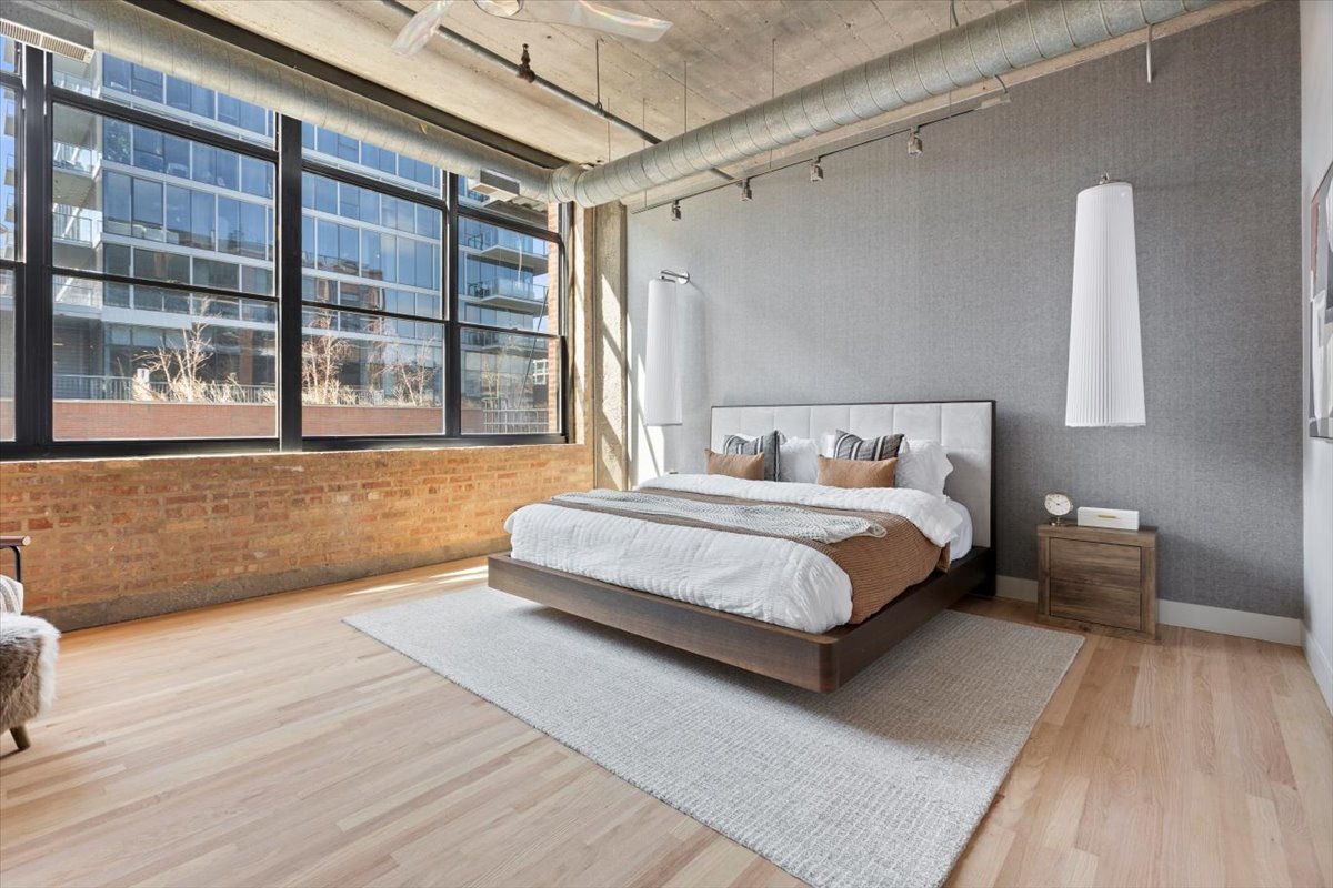 850 West Adams Street, Unit 4A Chicago, IL 60607 - Photo 29 of 52 a bedroom with a bed and a large window