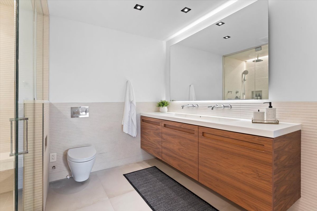 850 West Adams Street, Unit 4A Chicago, IL 60607 - Photo 40 of 52 a spacious bathroom with a double vanity sink and a toilet