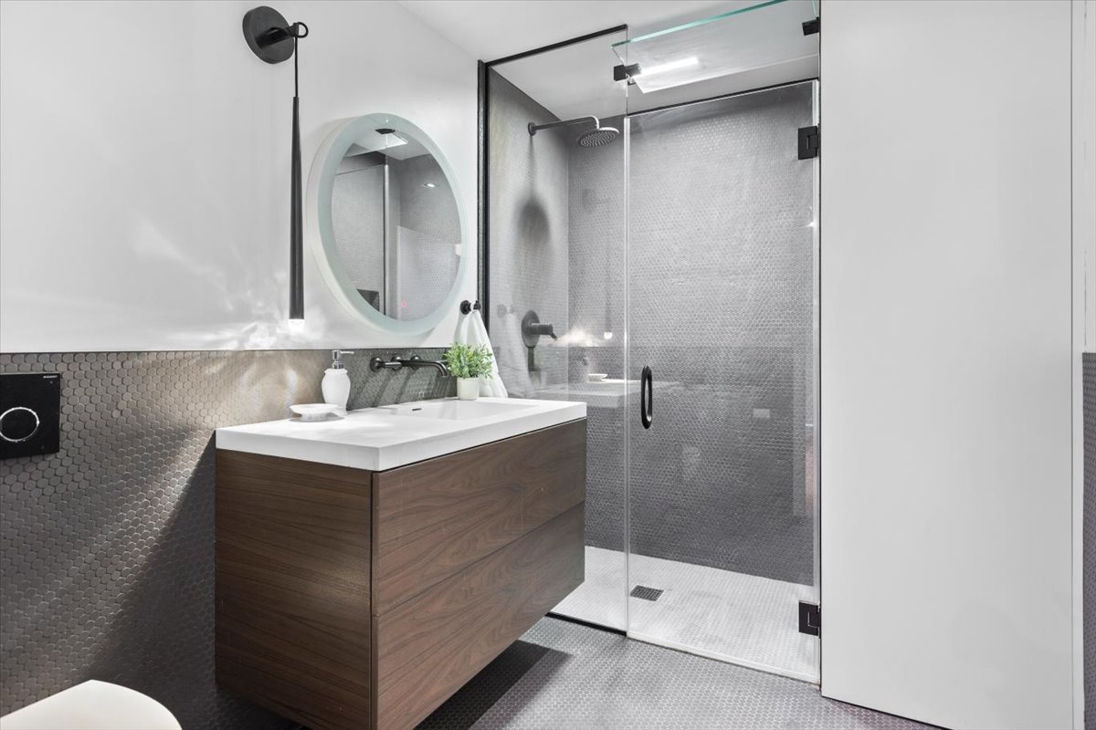 850 West Adams Street, Unit 4A Chicago, IL 60607 - Photo 48 of 52 a bathroom with a sink mirror and a shower