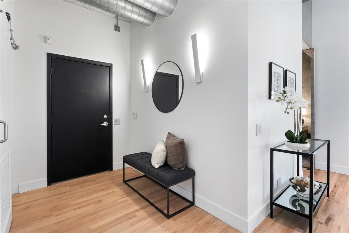 850 West Adams Street, Unit 4A Chicago, IL 60607 - Photo 5 of 52 a bedroom with a bed and a mirror