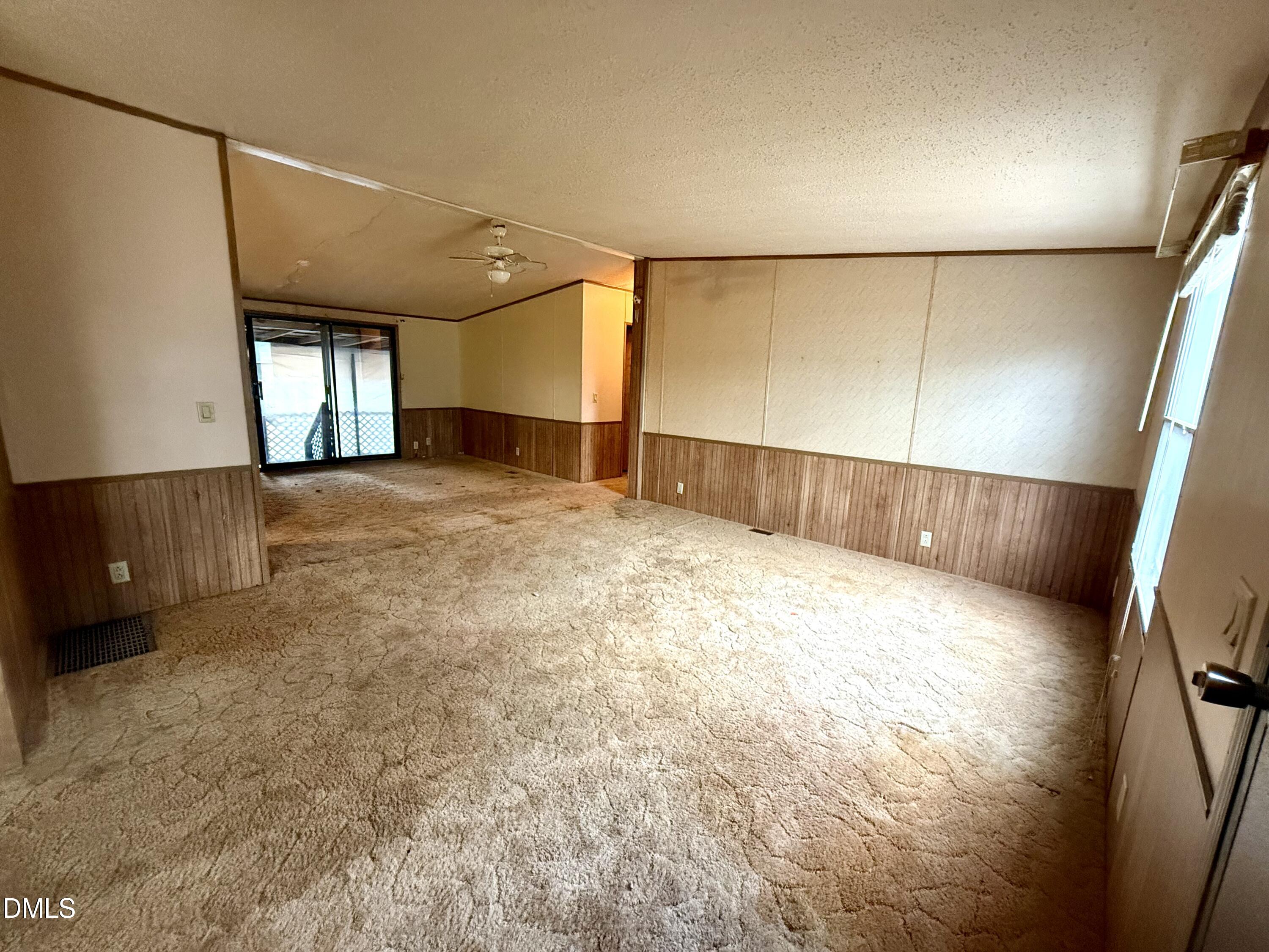 1969 Bagley Road Kenly, NC 27542 - Photo 15 of 23 a view of an empty room with wooden floor and a window