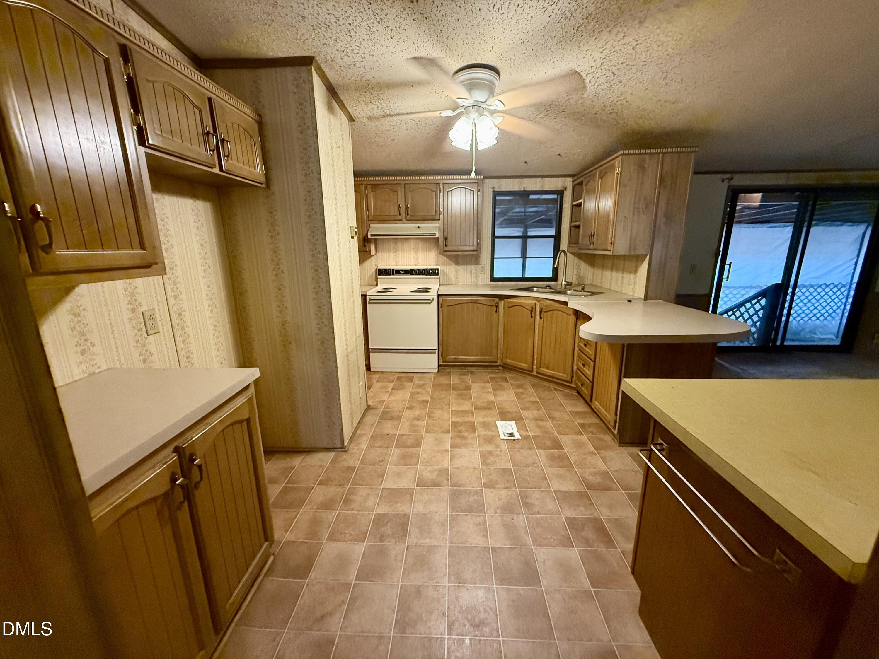 1969 Bagley Road Kenly, NC 27542 - Photo 18 of 23 a kitchen with a sink a stove top oven and cabinets